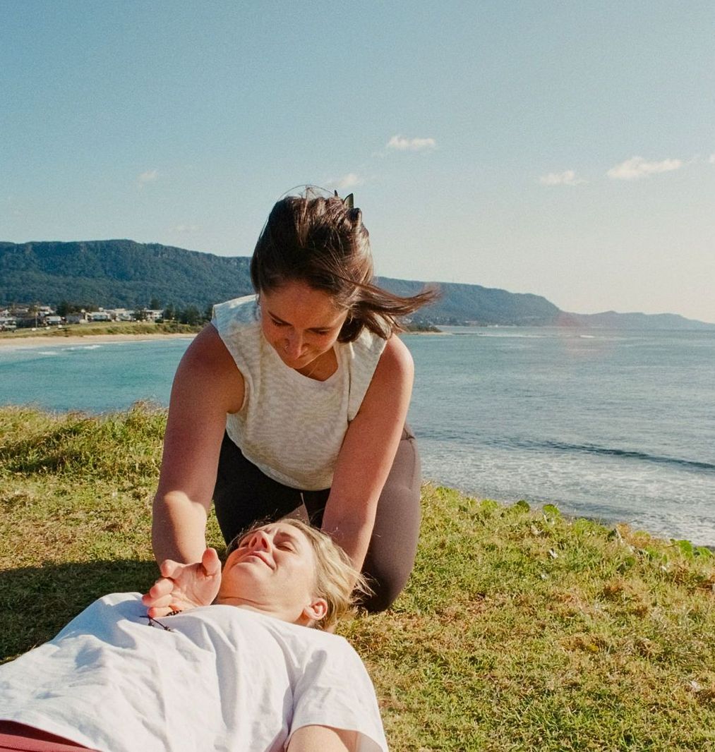 A Woman Is Kneeling Down on A Yoga Mat in Front of A Window — Align Health Therapies in Woonona, NSW