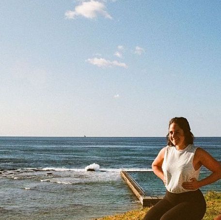 Three Women Are Sitting in A Lotus Position on Yoga Mats in A Gym — Align Health Therapies in Woonona, NSW