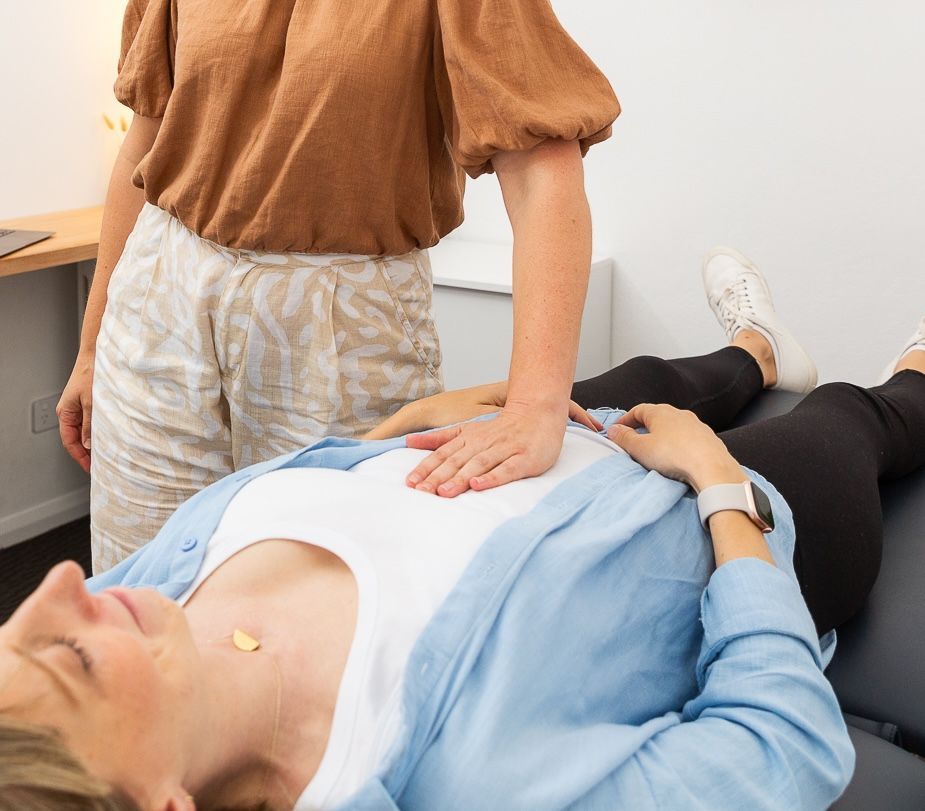 Practitioner performing hands-on osteopathy treatment on a woman