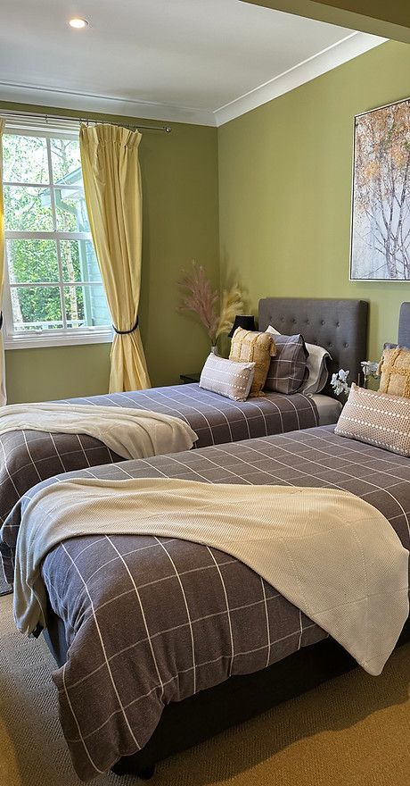 A Bedroom With Two Twin Beds and a Window — Align Health Therapies in Woonona, NSW