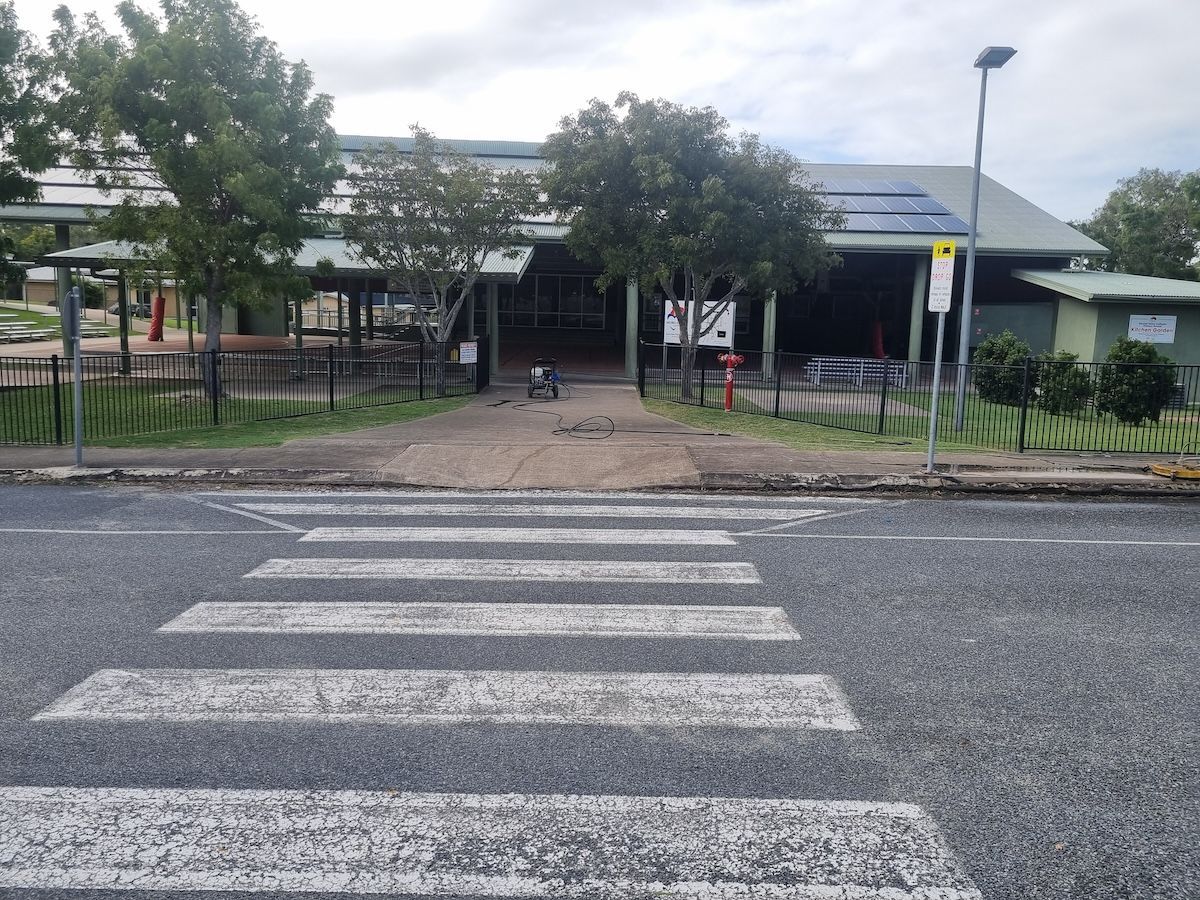 A Person Is Cleaning A Tiled Floor With A Machine — Cap Coast Pressure Cleaning in Lammermoor, QLD