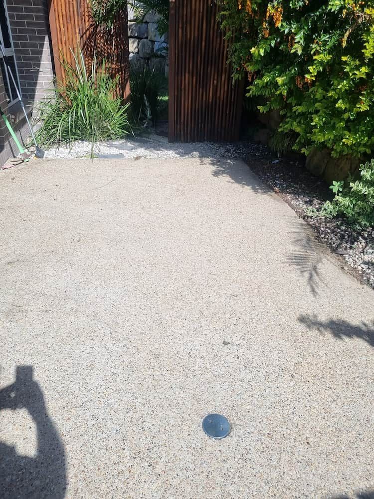 A Shadow Of A Person Is Cast On A Concrete Surface — Cap Coast Pressure Cleaning in Lammermoor, QLD
