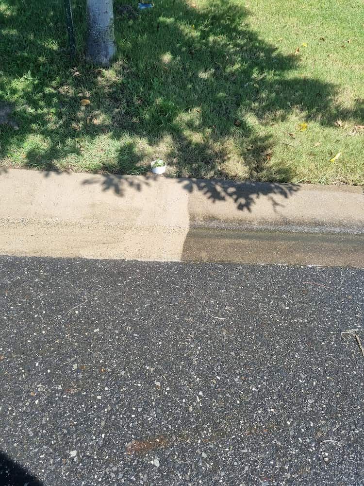 A Shadow Of A Tree Is Cast On The Side Of A Road — Cap Coast Pressure Cleaning in Lammermoor, QLD