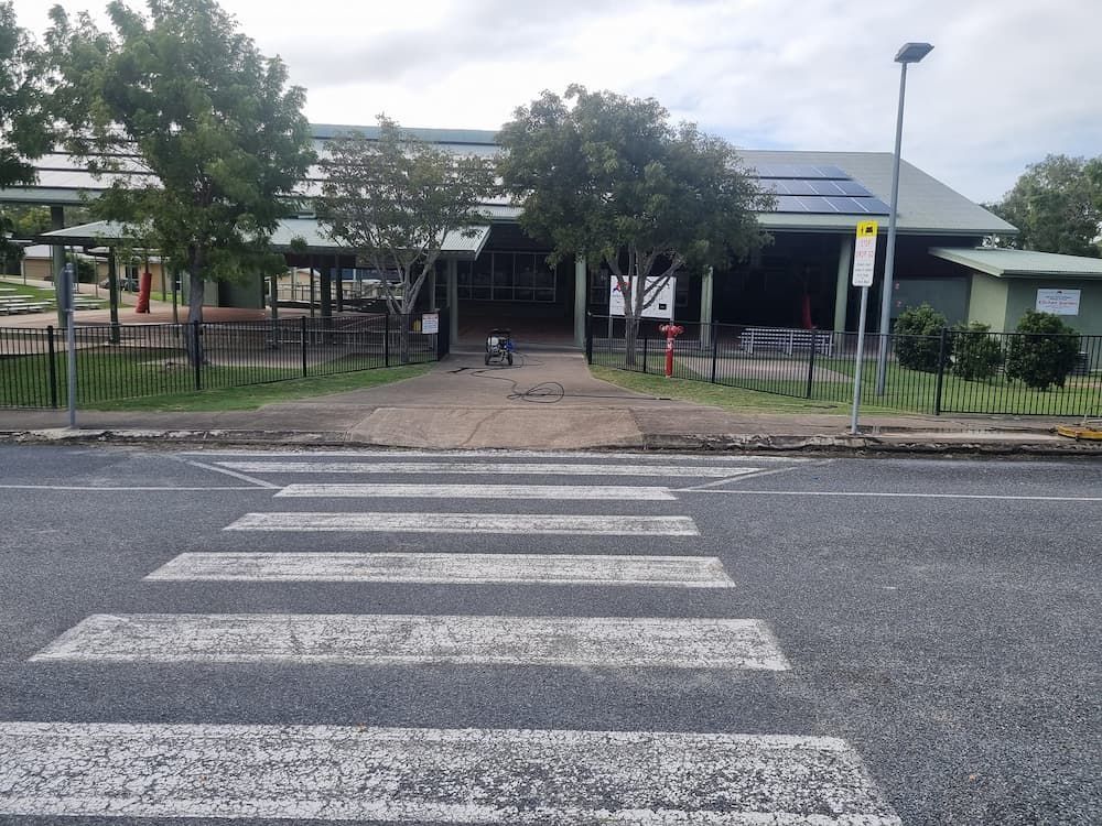 A Crosswalk In Front Of A School Building — Cap Coast Pressure Cleaning in Lammermoor, QLD