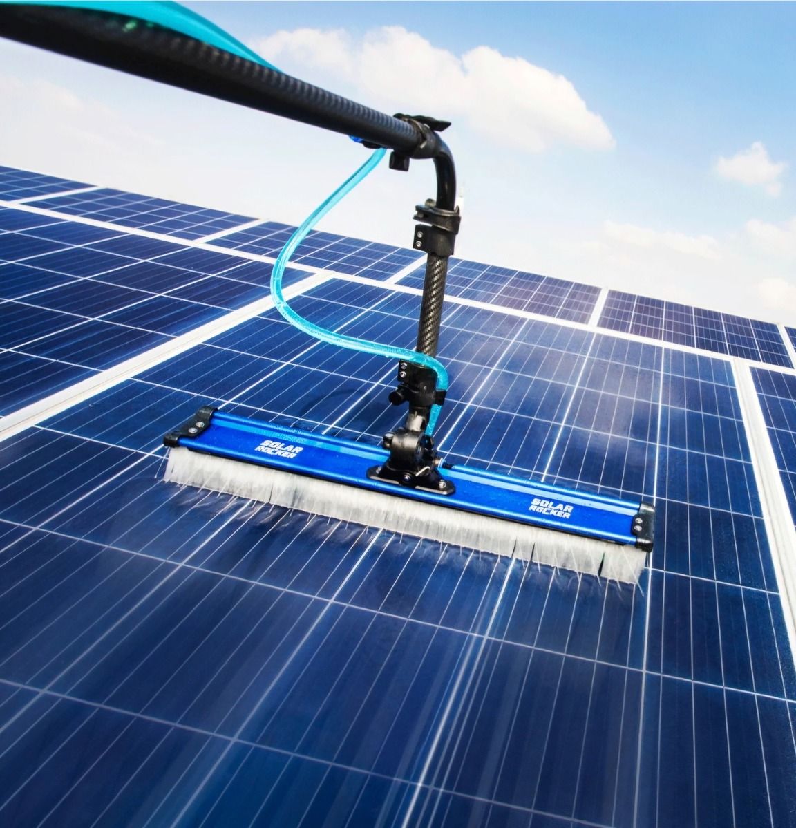 A Brush Is Being Used to Clean a Solar Panel — Cap Coast Pressure Cleaning in Lammermoor, QLD