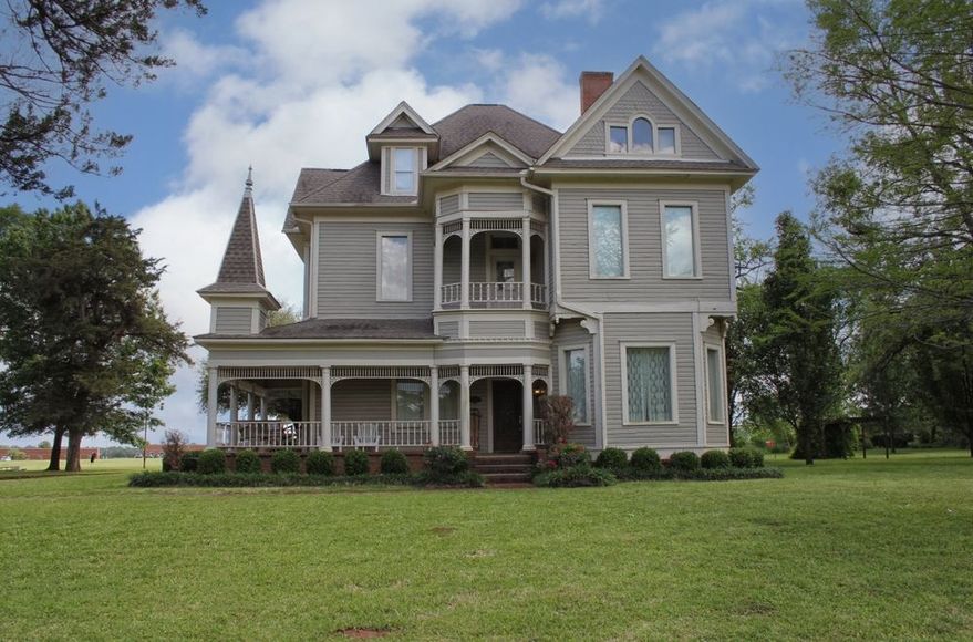 A large house with a tower on top of it