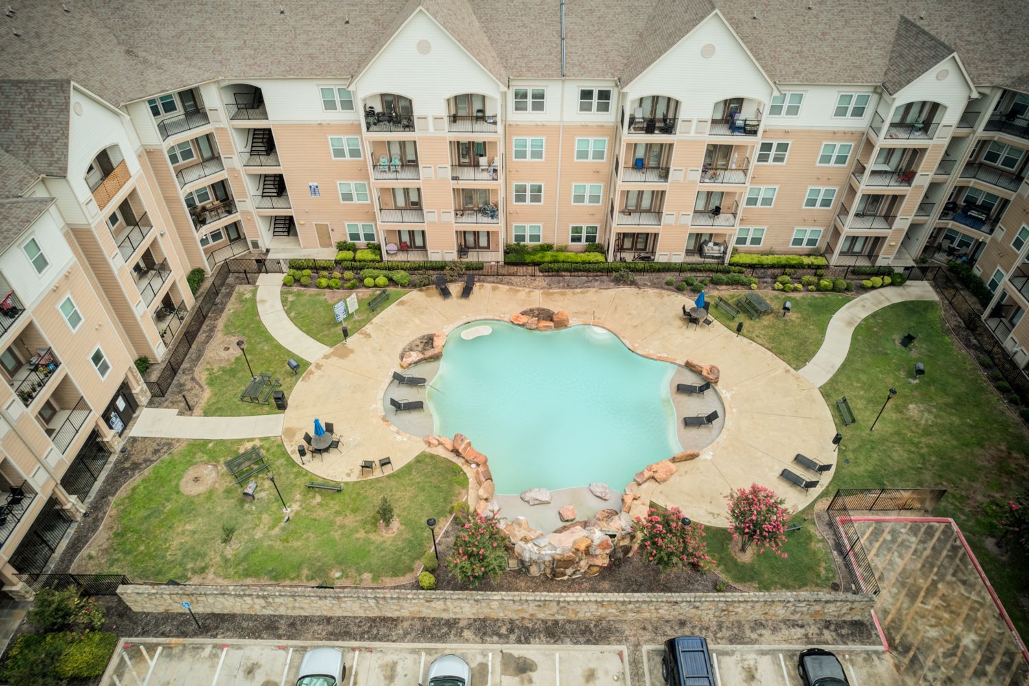 Bay Vista apartment exterior view with walking path to outdoor grill station.