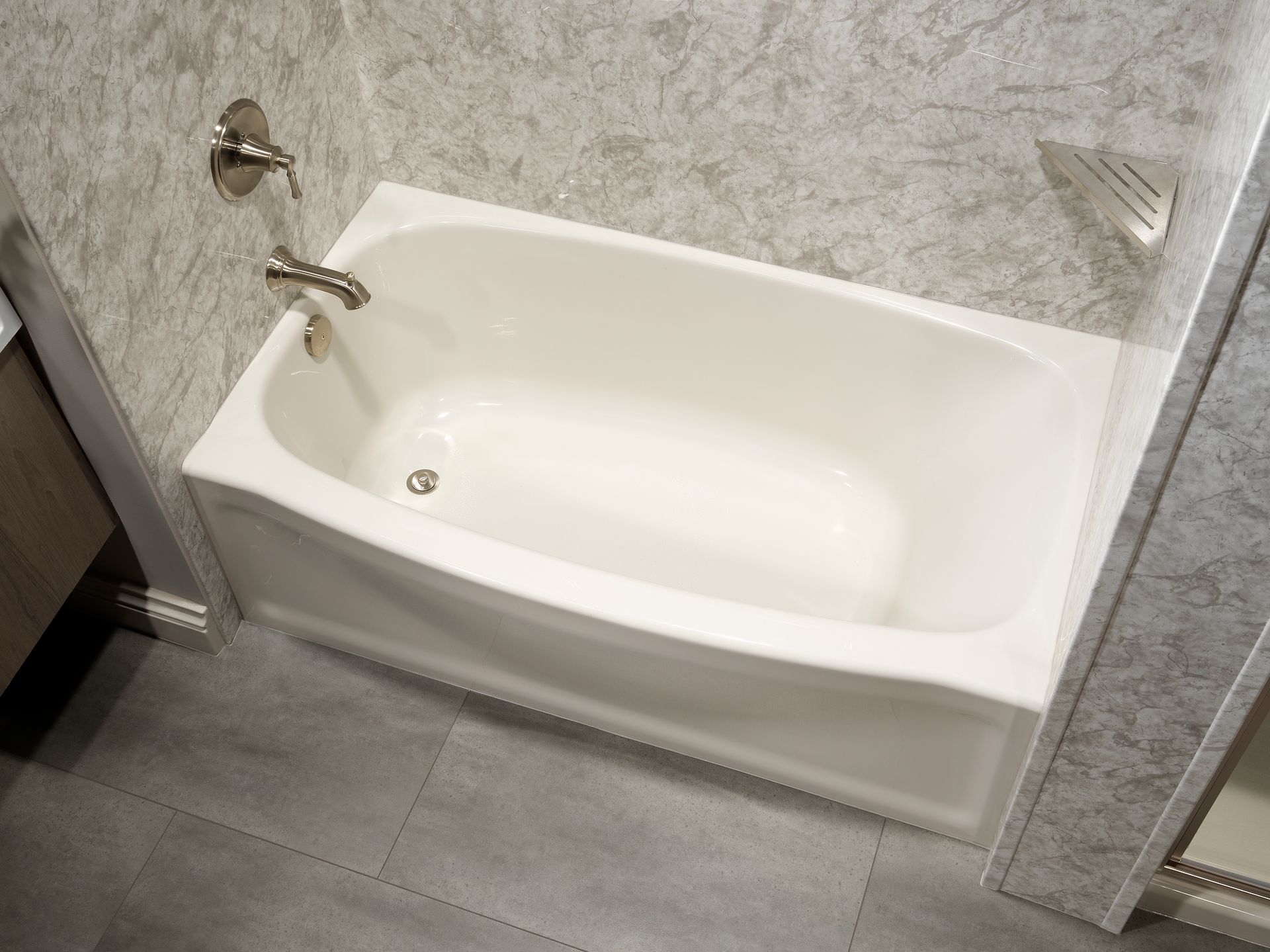 A white bathtub is sitting in a bathroom next to a shower.