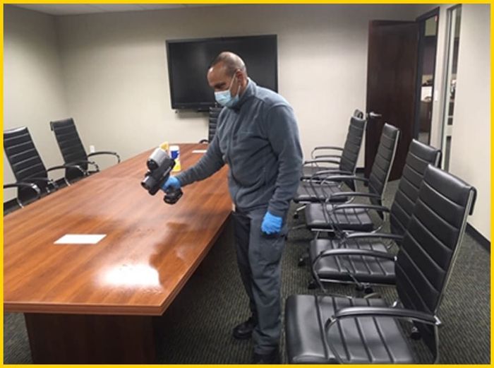 Male employee cleaning an office