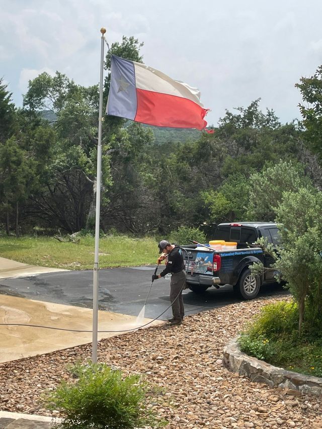 A man is standing in front of a texas flag