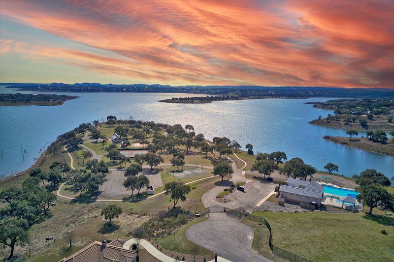 A texas flag is flying in front of a city skyline.