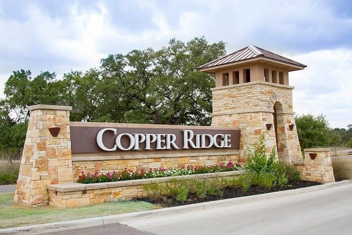 A large building with a clock tower is lit up at night.