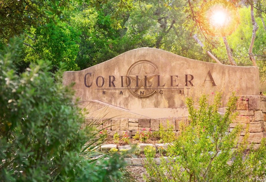 A large building with a clock tower is lit up at night.