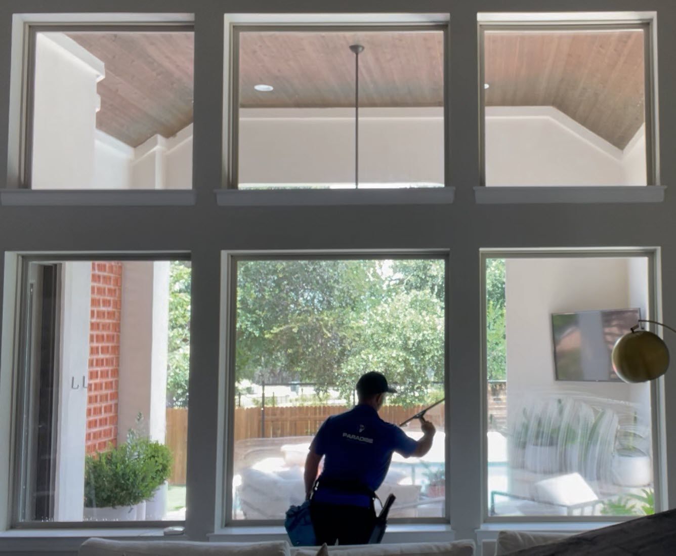 Paradise Pro Wash technician cleaning windows in Boerne
