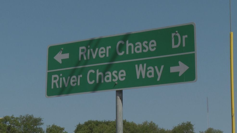 A large building with a clock tower is lit up at night.