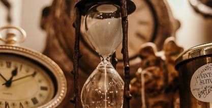 Antique hourglass and clock