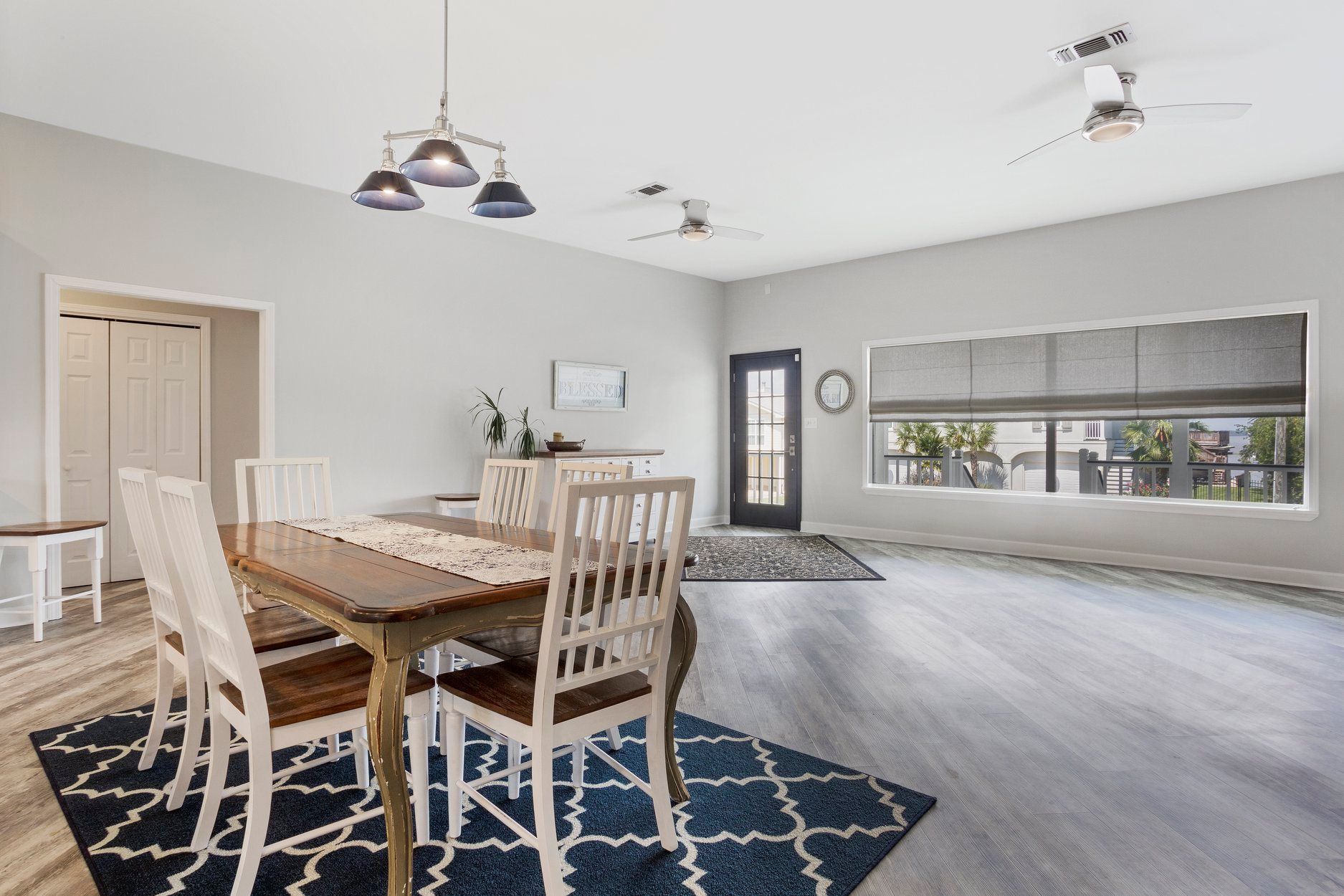 A dining room with a table and chairs and a rug