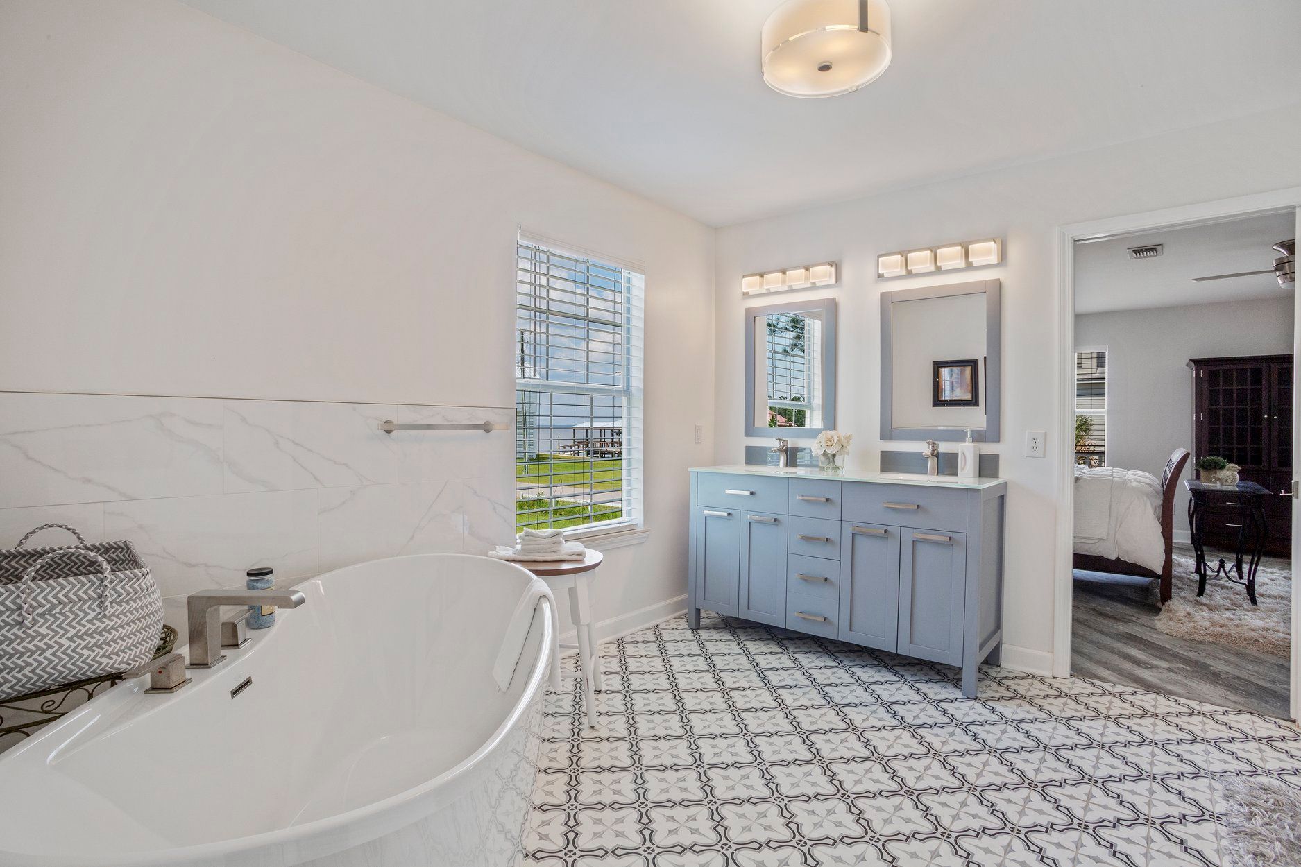 A bathroom with a bathtub and two sinks.