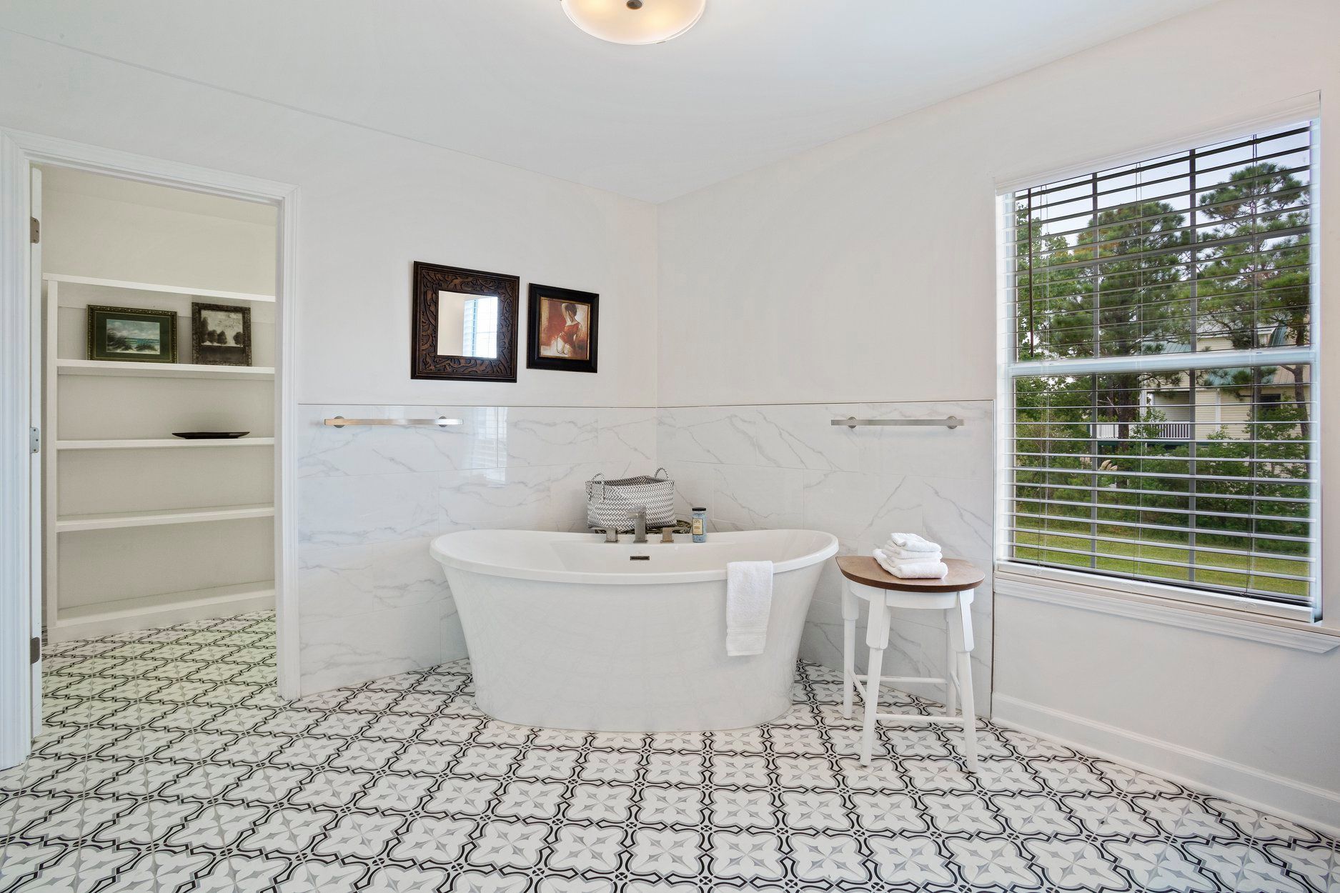 A bathroom with a bathtub and a window