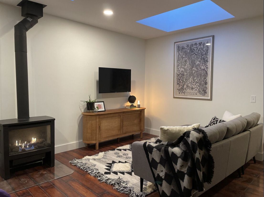 A living room with a couch a fireplace and a flat screen tv