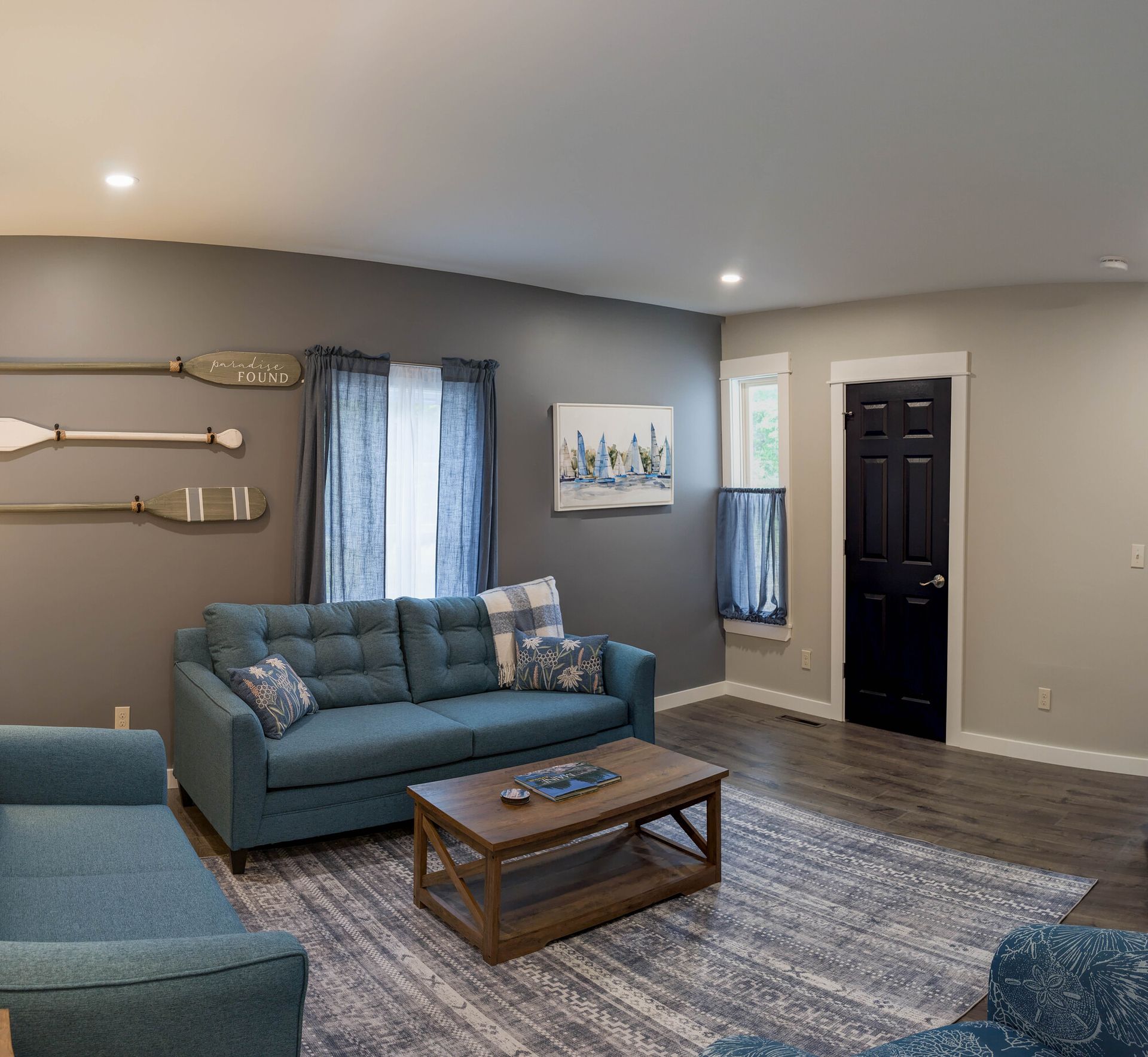 A living room with a blue couch and a coffee table