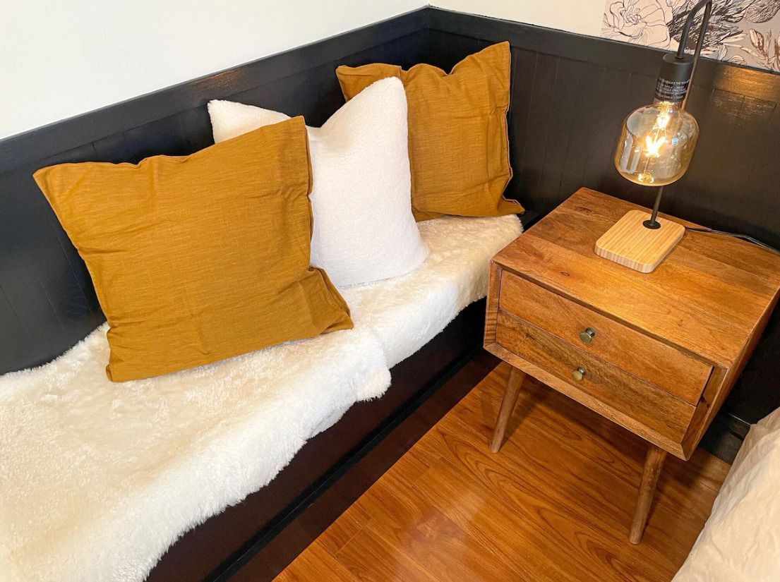 A living room filled with furniture and a skylight.