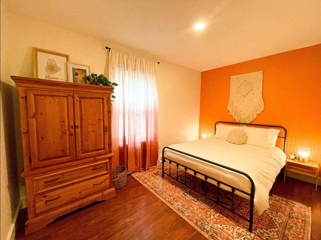 A house with a red deck and a blue sky in the background.