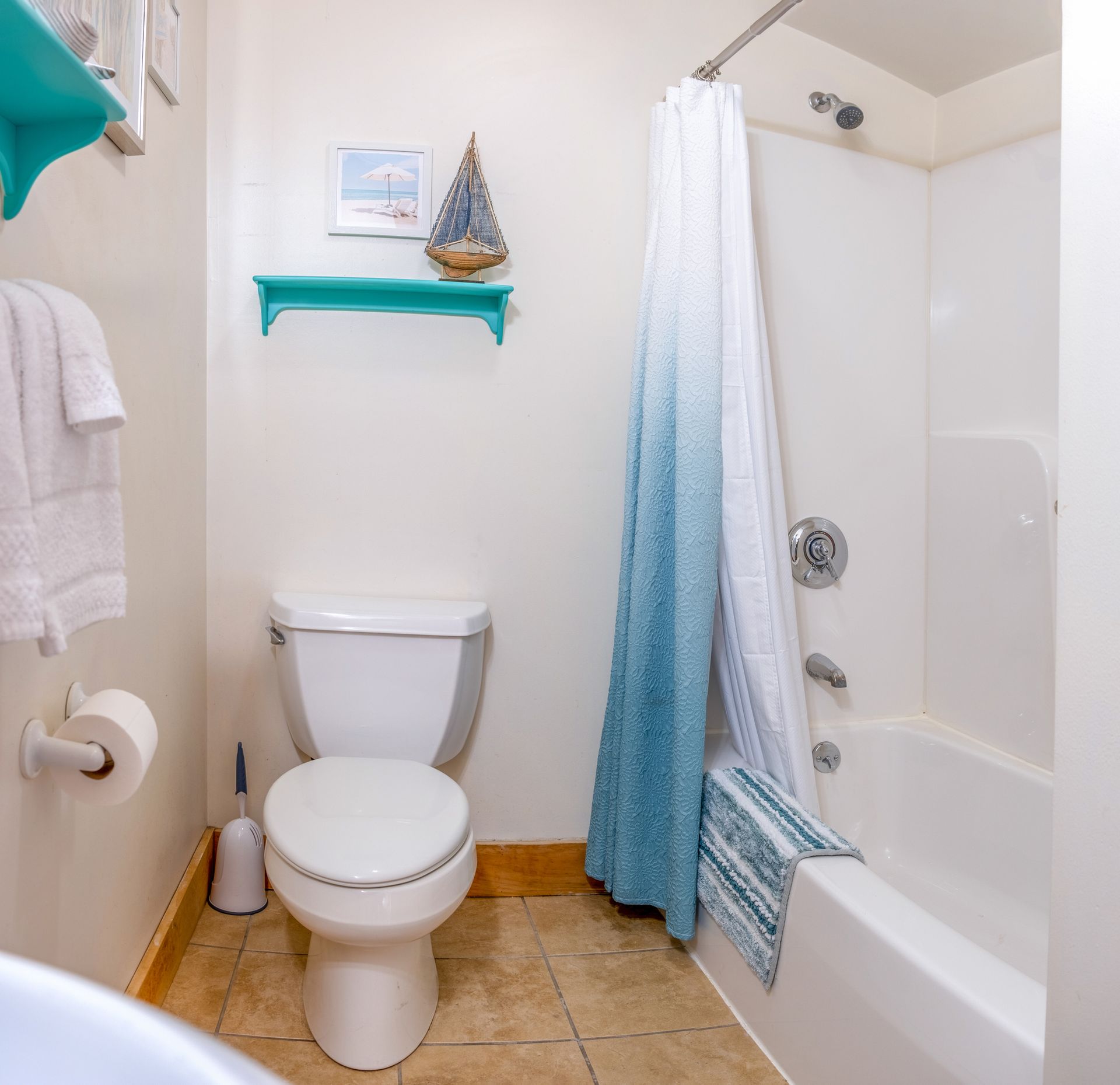 A bathroom with a toilet a bathtub and a shower curtain