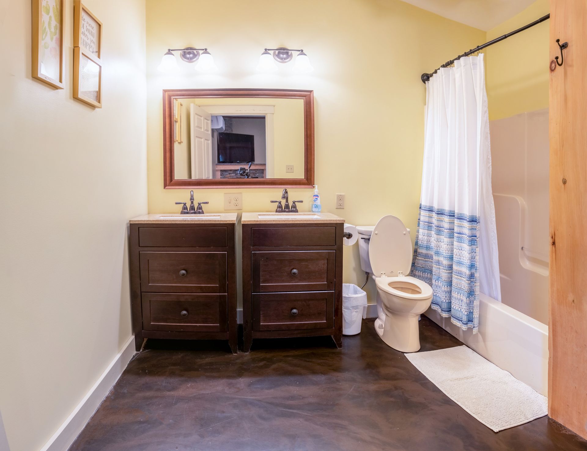 A bathroom with two sinks , a toilet , and a bathtub.