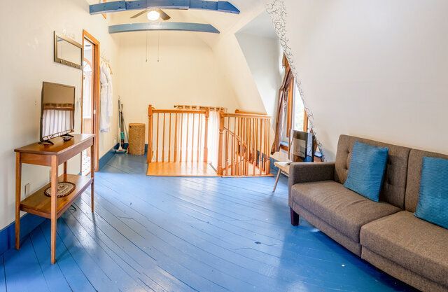A living room with a blue floor and a couch.
