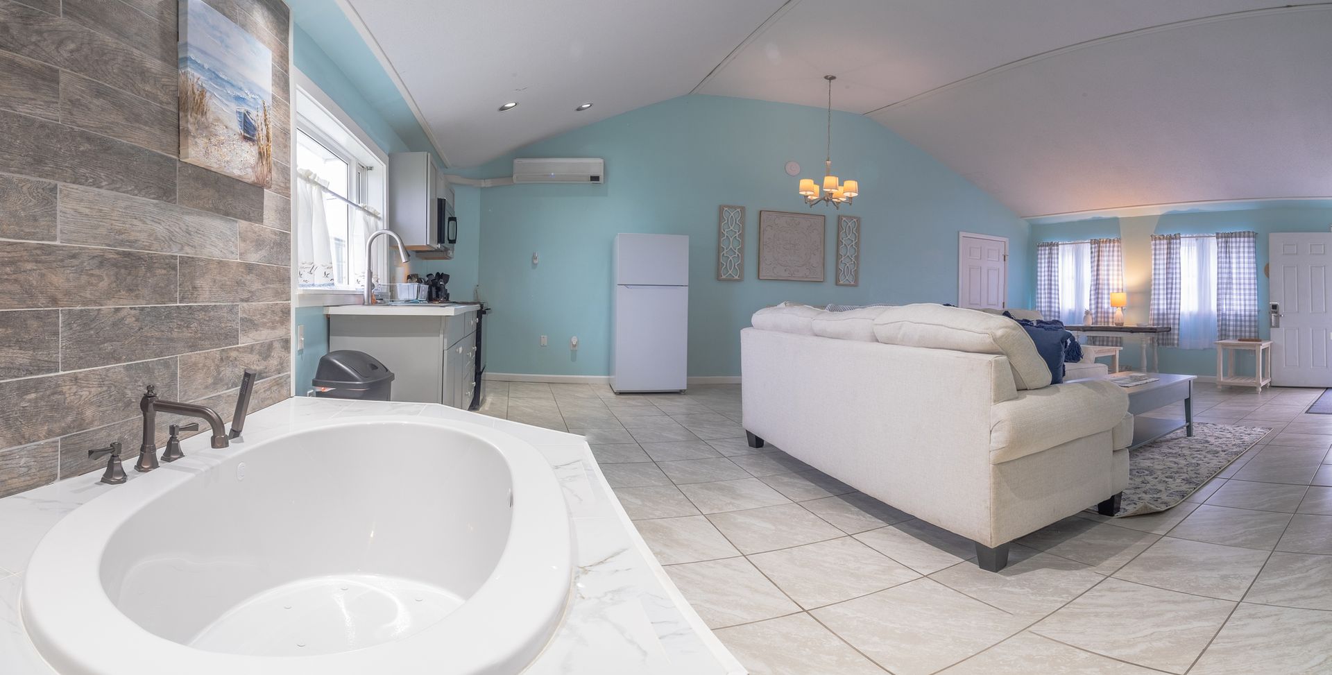 There is a jacuzzi tub in the middle of the living room.