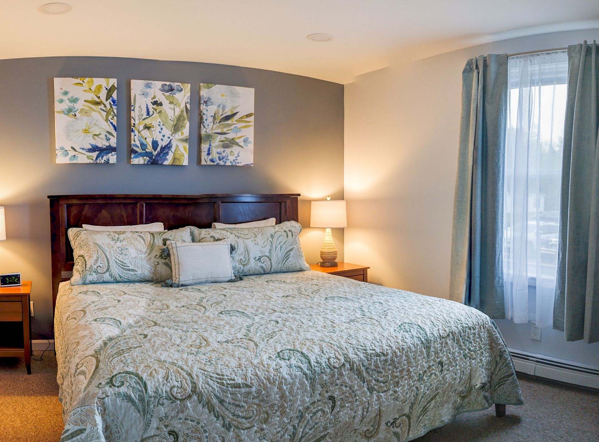 A living room with a couch , television , and blue floors.