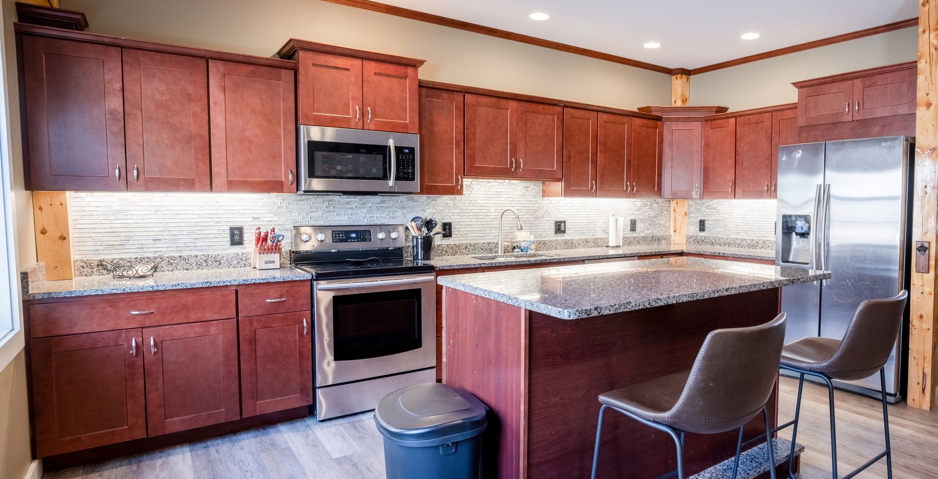 A kitchen with stainless steel appliances and wooden cabinets.