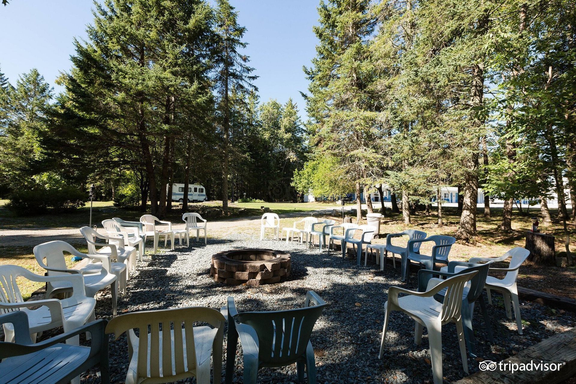A group of chairs and tables around a fire pit