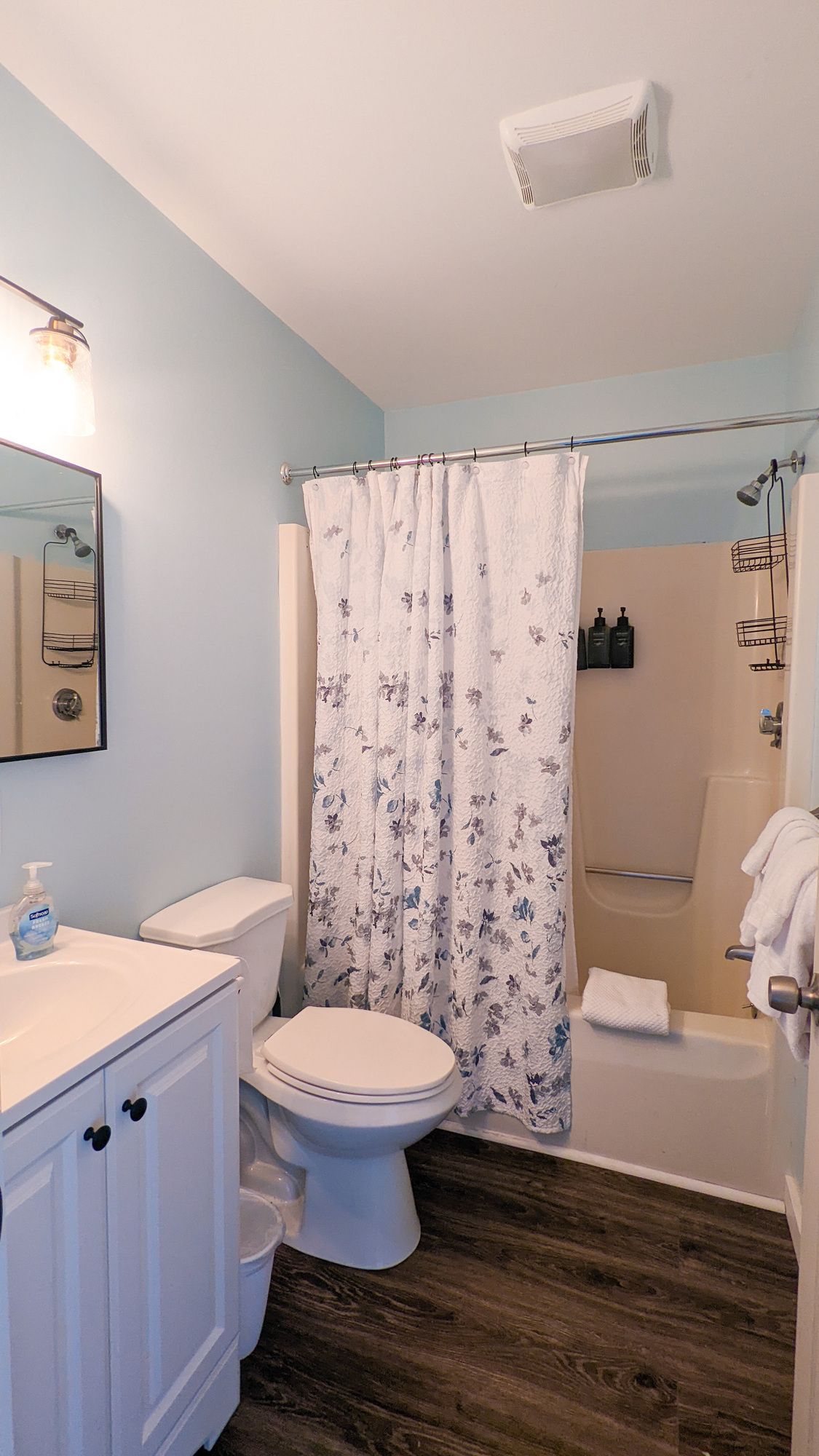 A bathroom with a toilet , sink , shower and bathtub.