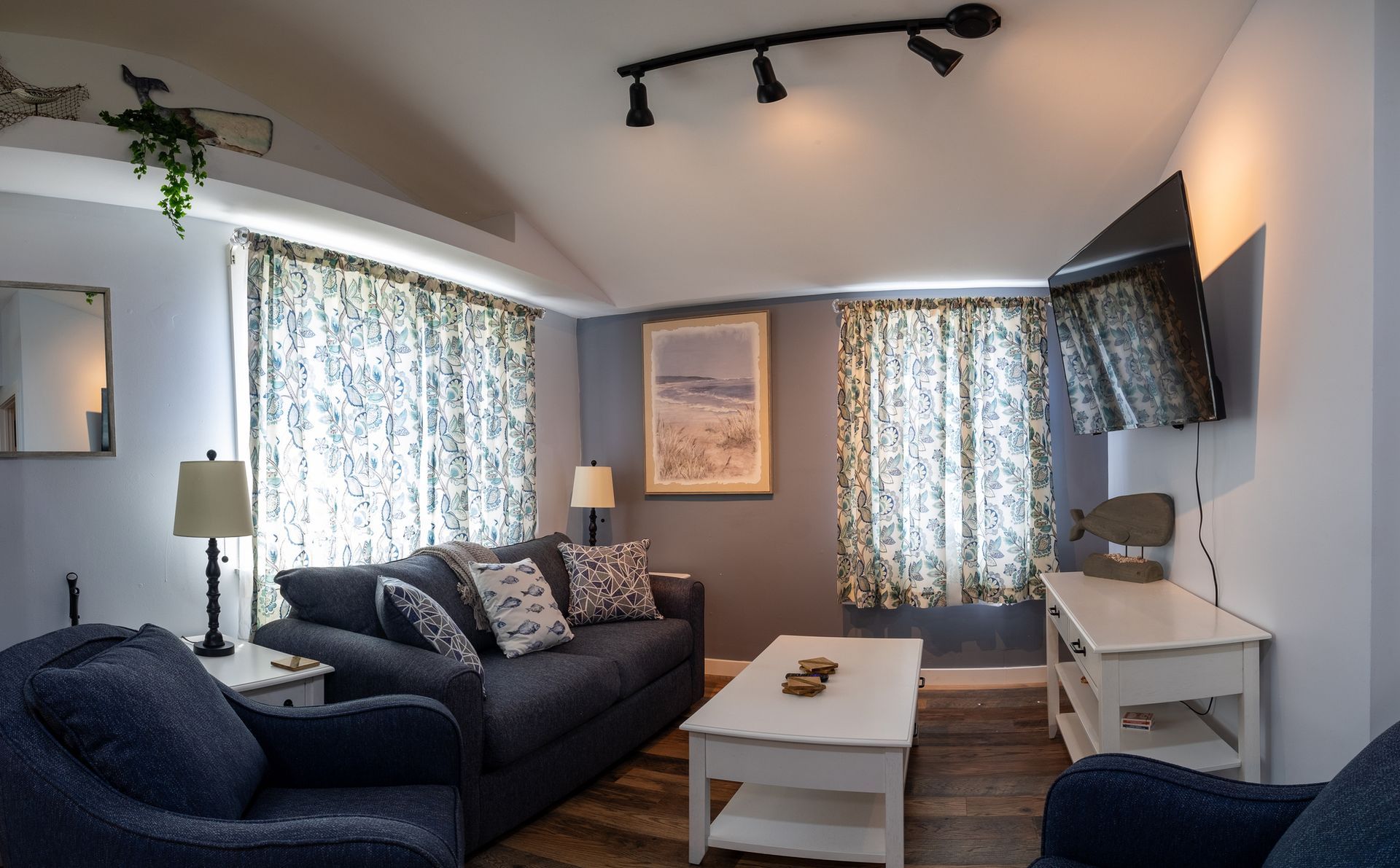 A living room with a couch and two chairs