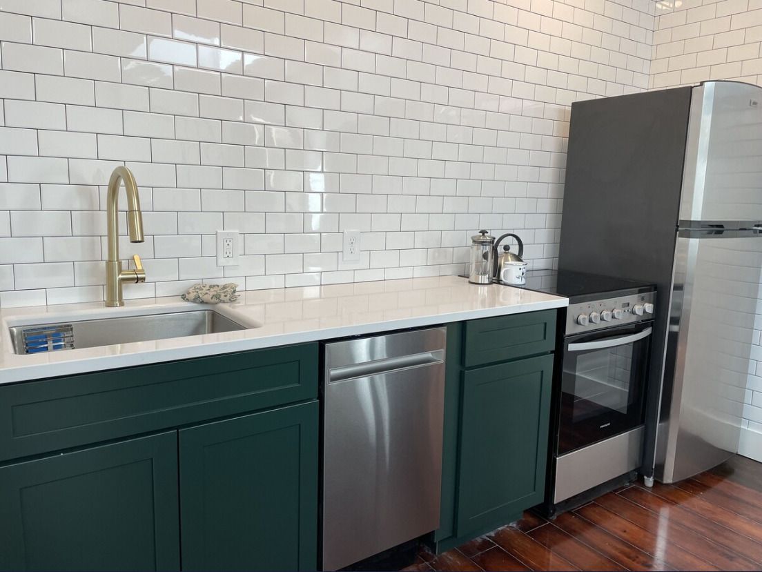 A bathroom with two sinks and a large mirror.