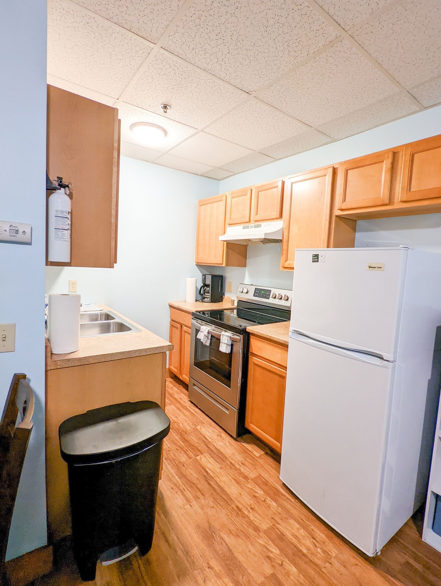 A kitchen with wooden cabinets and a white refrigerator