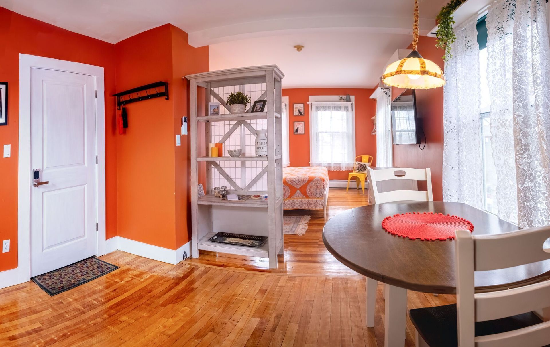 There is a table and chairs in the middle of the room.