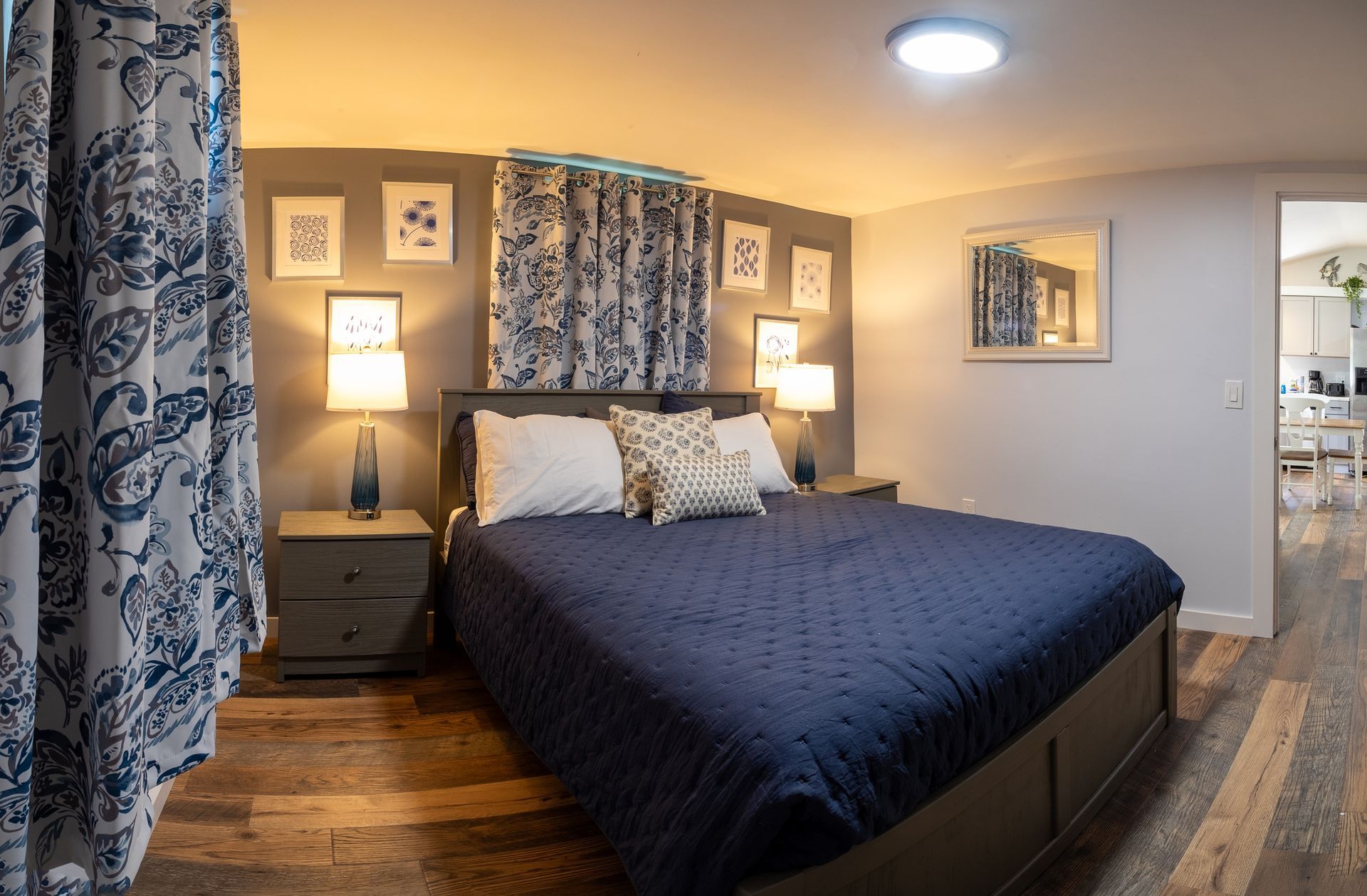 A bedroom with a king size bed and two nightstands