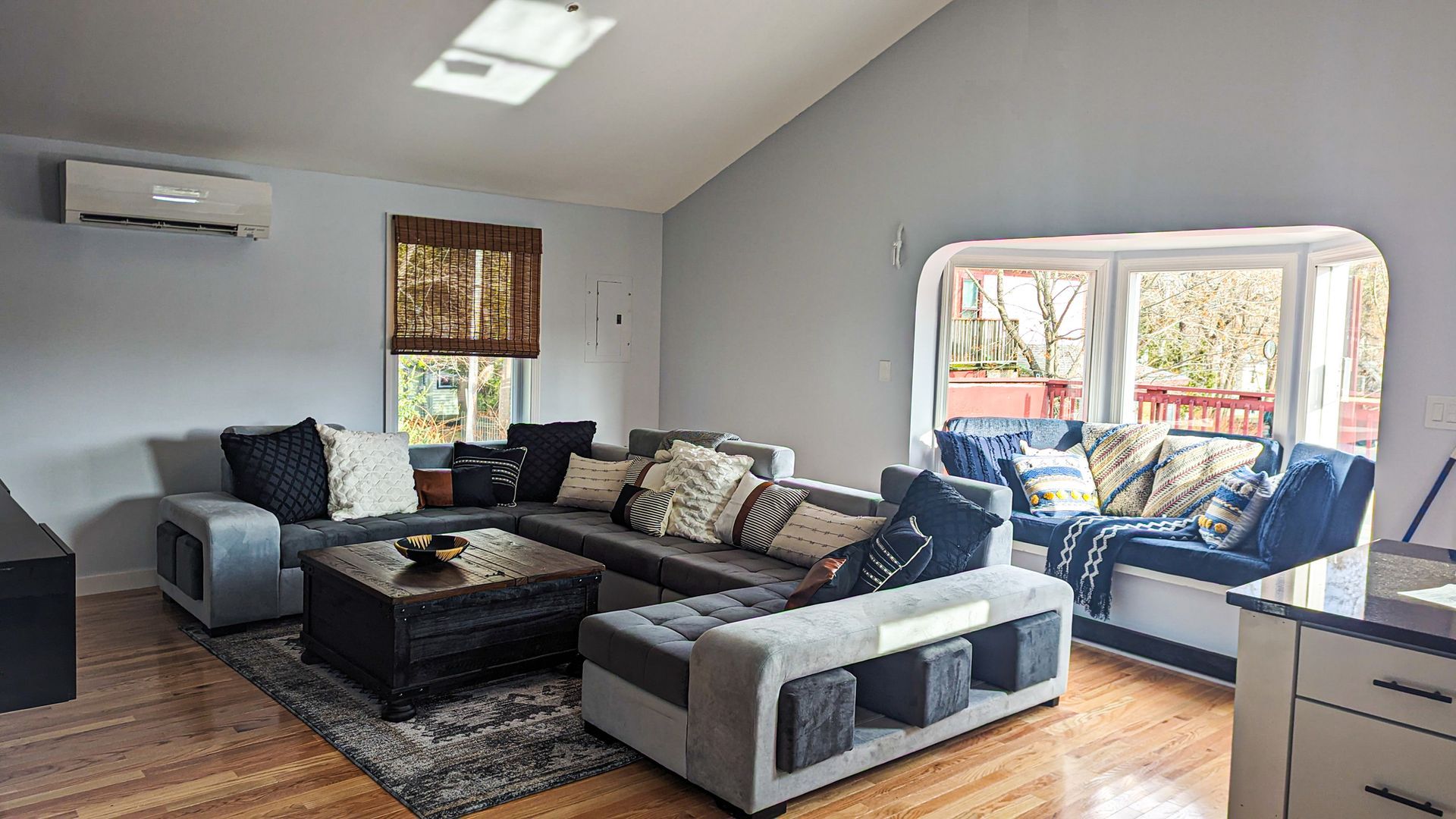 A living room filled with furniture and a skylight.