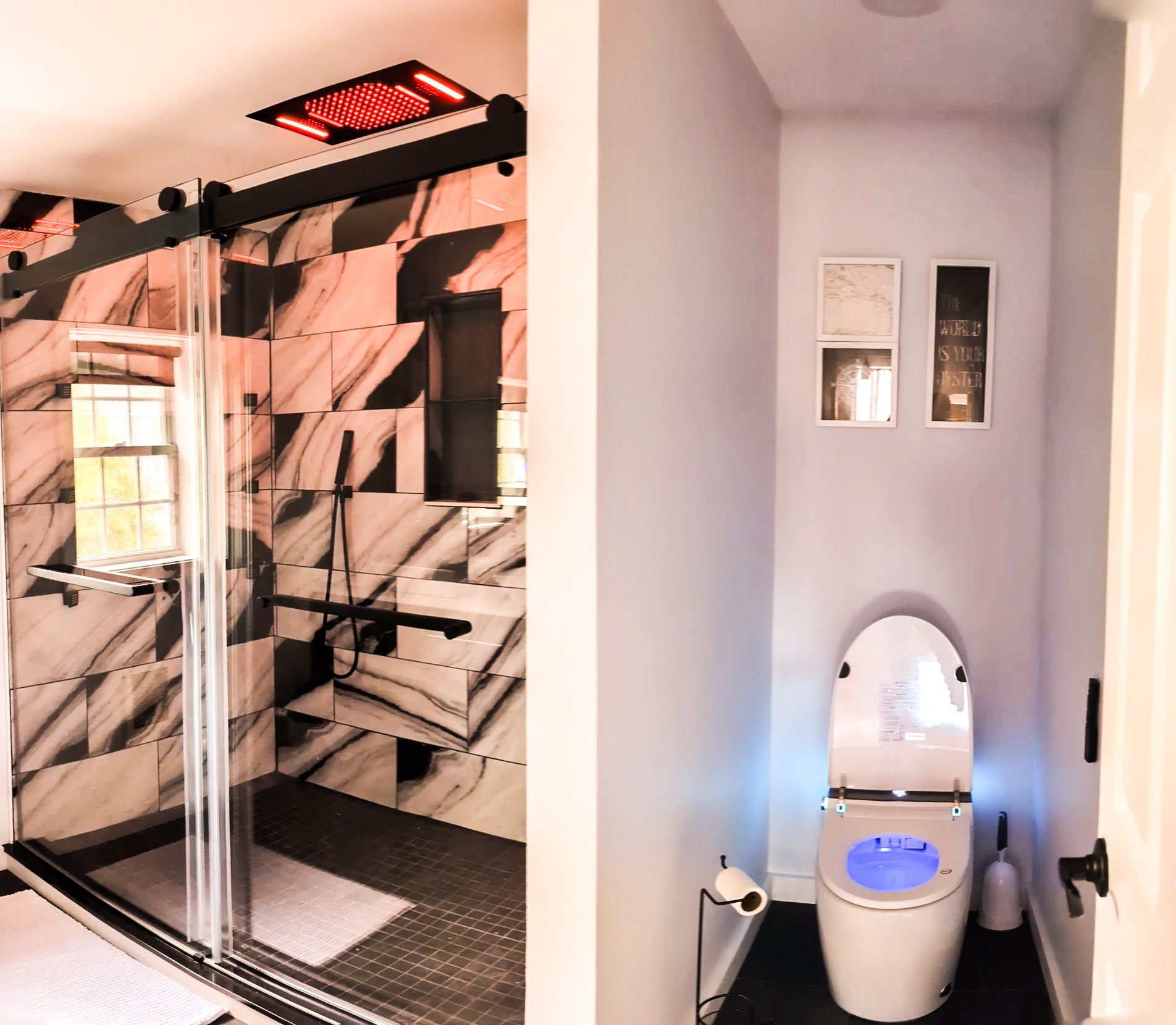 A bathroom with a toilet and a shower stall