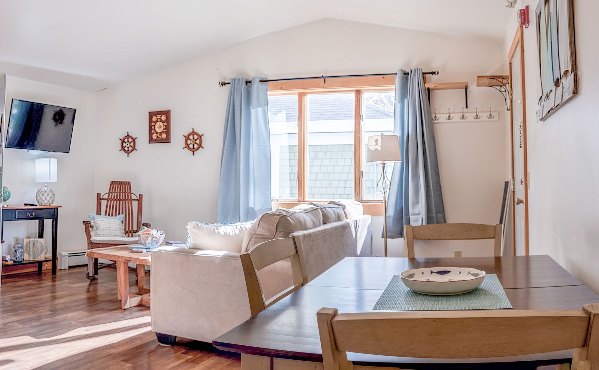A living room with a table and chairs and a couch.