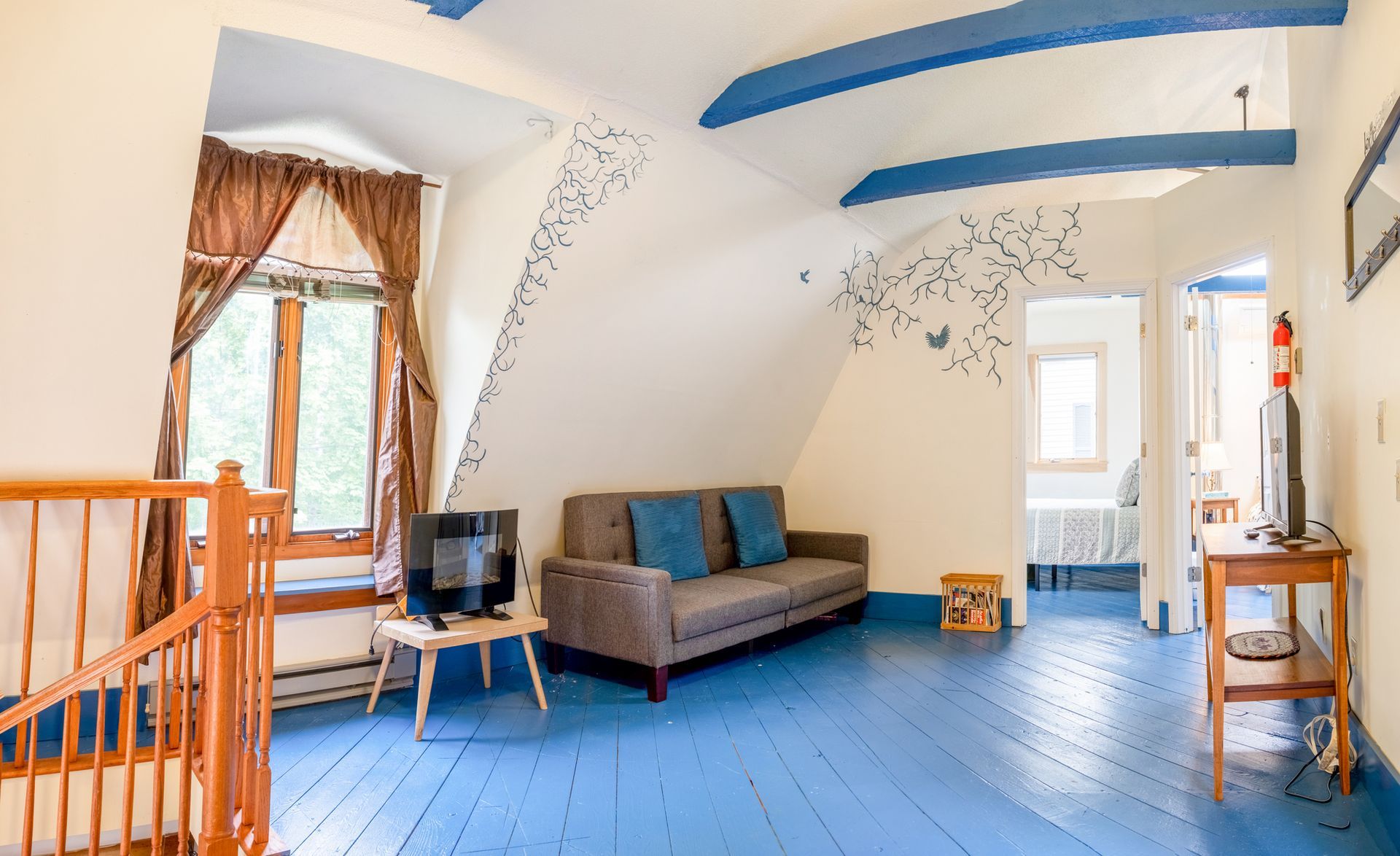 A living room with a couch and a television