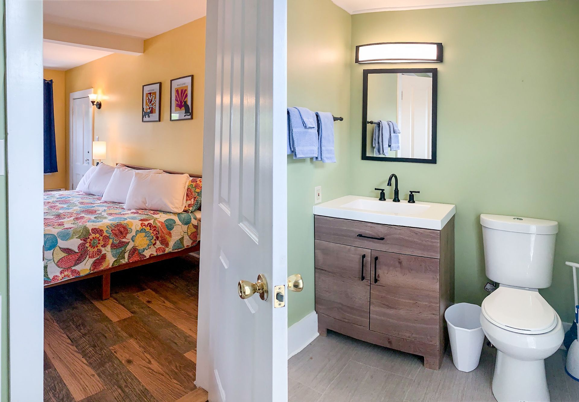 A bathroom with a toilet , sink and mirror