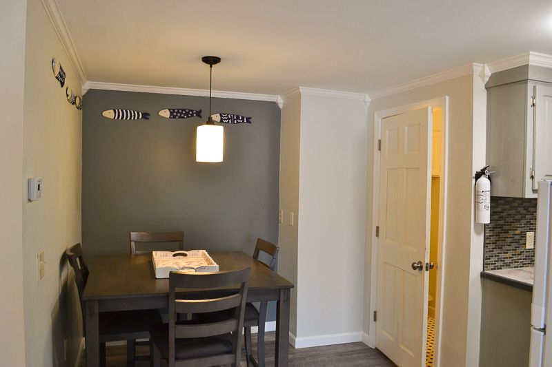 A dining room with a table and chairs in it