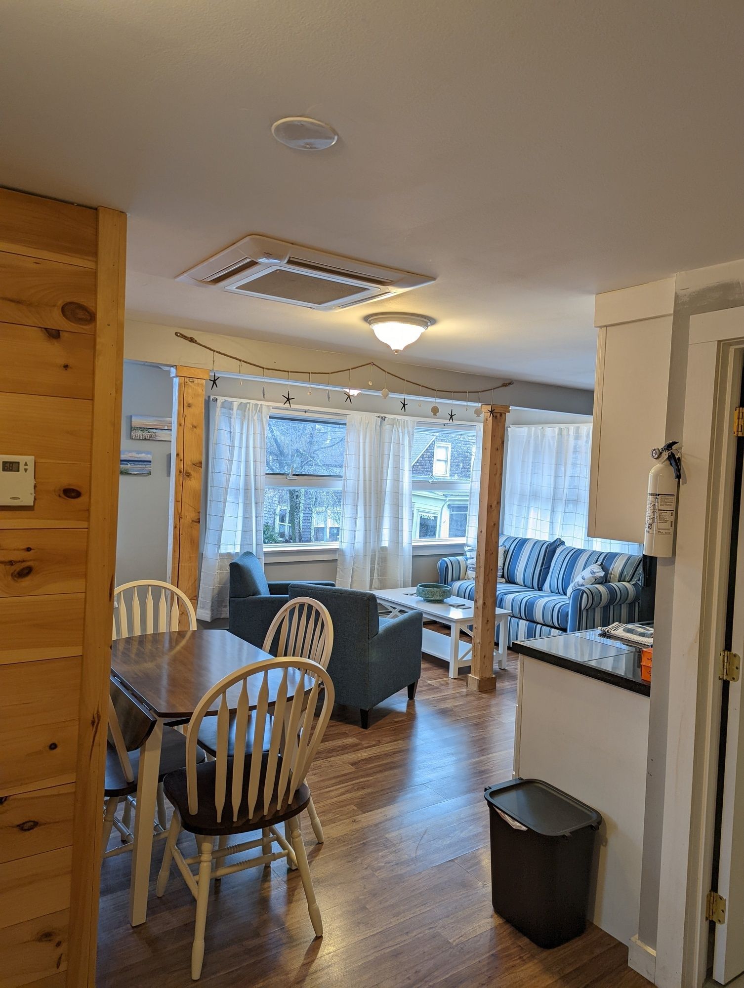 A living room with a dining table and chairs and a couch.
