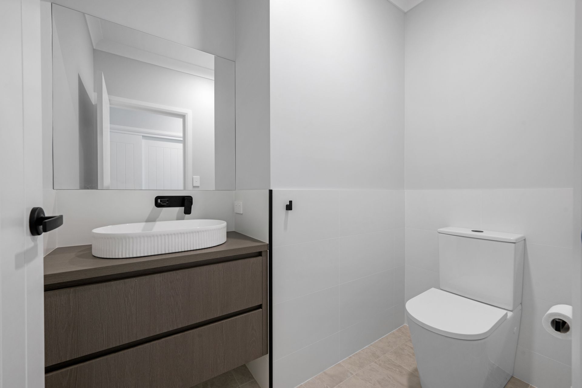 A bathroom with a sink , toilet and mirror.