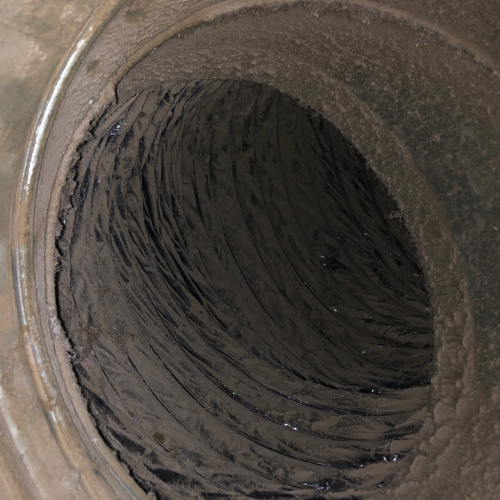 A close up of a dirty pipe with a hole in the middle