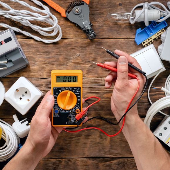 An empty kitchen with hardwood floors and a ceiling fan.